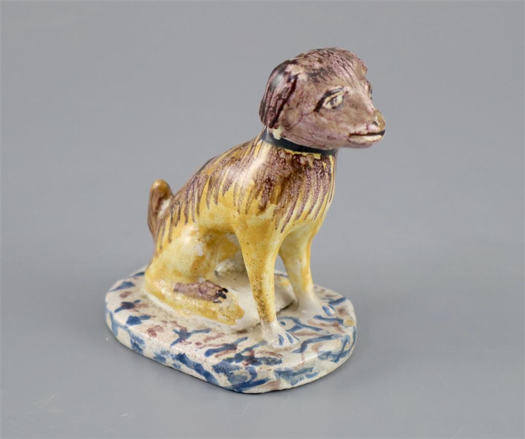 A Continental faience model of a seated dog, mid 18th century, possibly Brussels,
